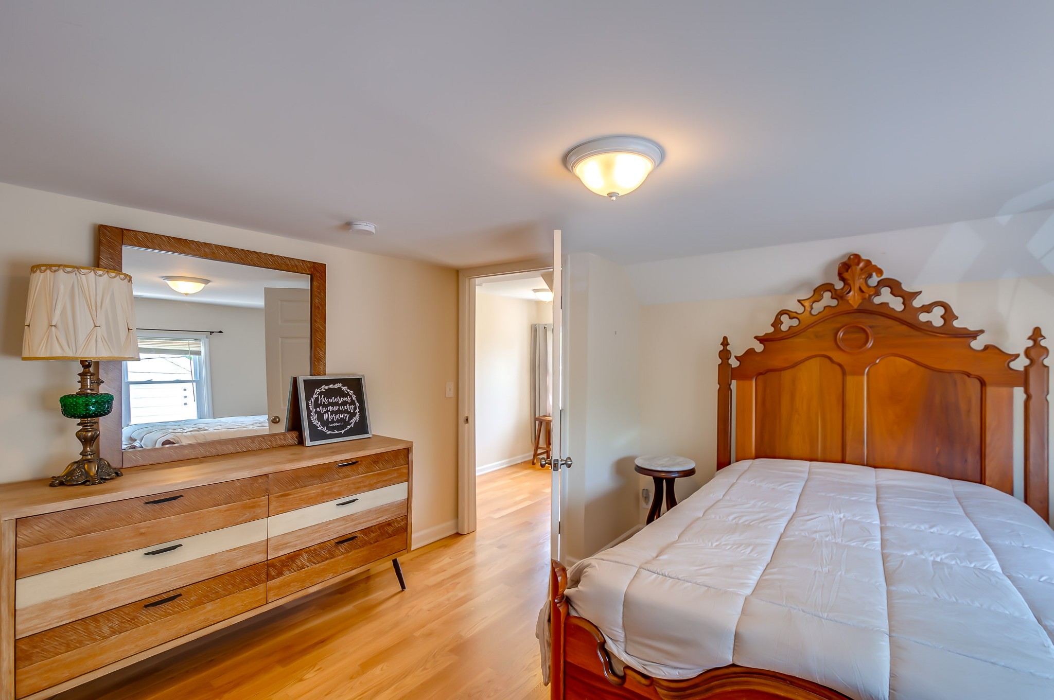 431 Maple Street Madison, TN 37115 - Photo 32 of 42 a bedroom with a bed and a lamp on dresser