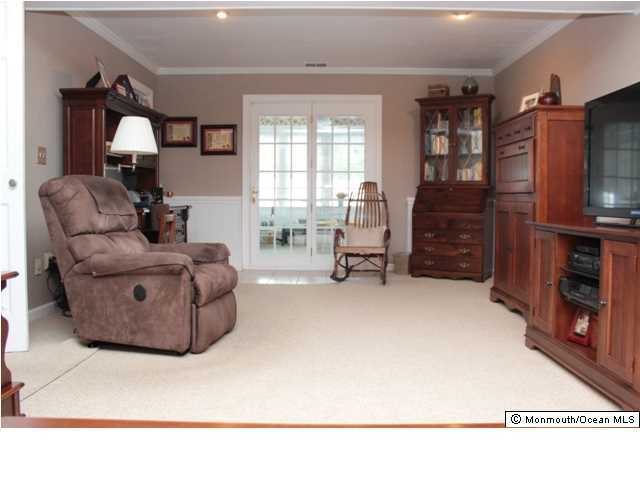 583 Robin Hood Road Brick, NJ 08724 - Photo 14 of 24 a living room with furniture and a flat screen tv