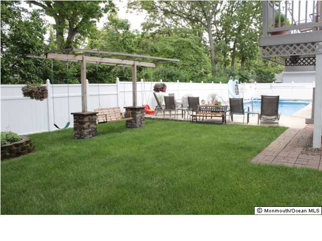 583 Robin Hood Road Brick, NJ 08724 - Photo 19 of 24 a backyard with table and chairs and potted plants