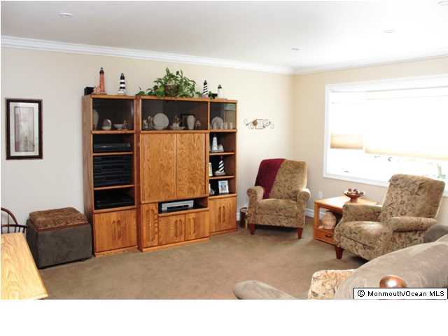 583 Robin Hood Road Brick, NJ 08724 - Photo 4 of 24 a living room with furniture gym equipment and a flat screen tv