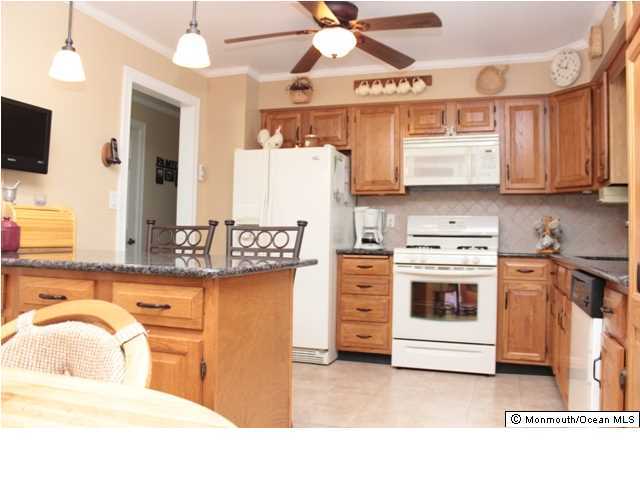 583 Robin Hood Road Brick, NJ 08724 - Photo 7 of 24 a kitchen with stainless steel appliances kitchen island granite countertop a sink and cabinets