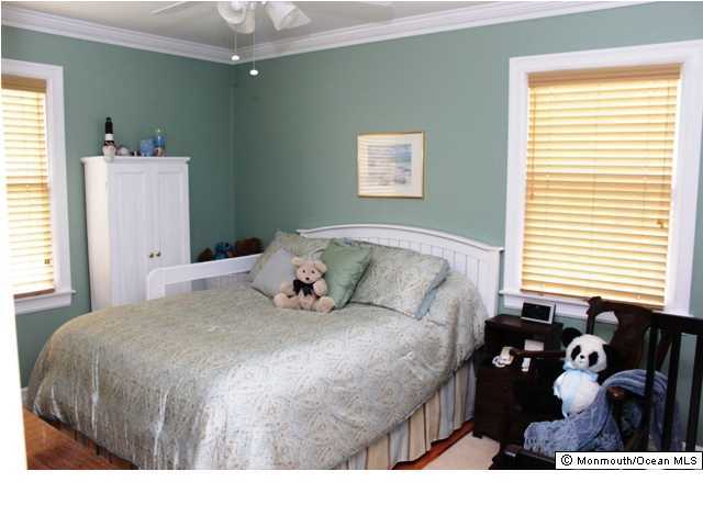 583 Robin Hood Road Brick, NJ 08724 - Photo 8 of 24 a bedroom with a bed and a chandelier