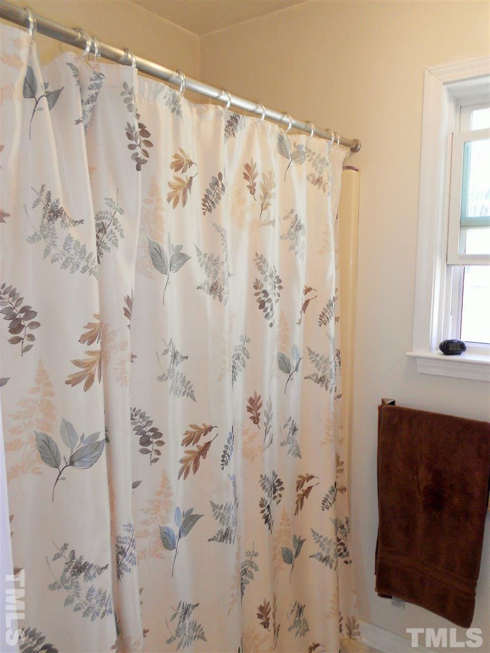 4535 Sugar Maple Road Oxford, NC 27565 - Photo 12 of 25 a bathroom with a shower curtain and a window