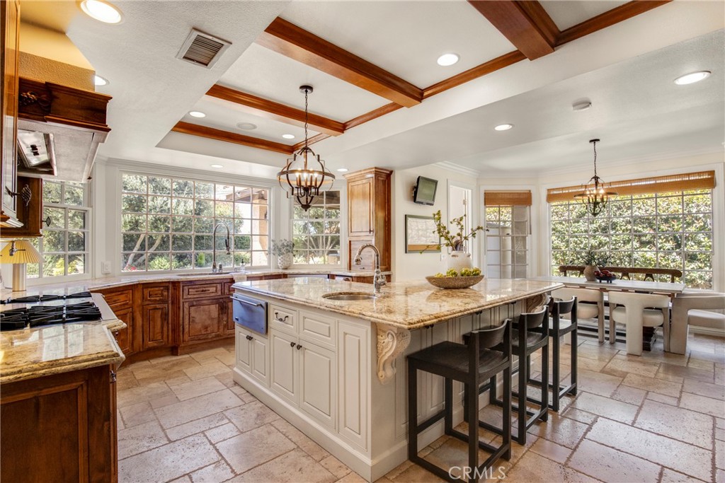 6032 Grey Rock Road Agoura Hills, CA 91301 - Photo 11 of 54 a kitchen with a table chairs stove and cabinets