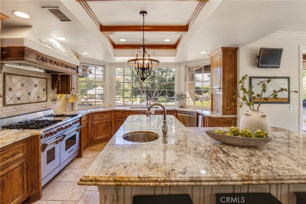 6032 Grey Rock Road Agoura Hills, CA 91301 - Photo 12 of 54 a kitchen with stainless steel appliances granite countertop a stove and a sink