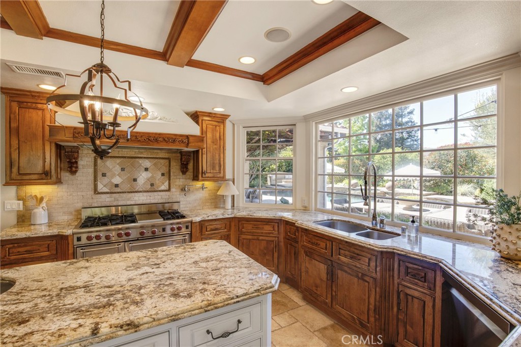 6032 Grey Rock Road Agoura Hills, CA 91301 - Photo 13 of 54 a kitchen with stainless steel appliances granite countertop a sink stove and cabinets