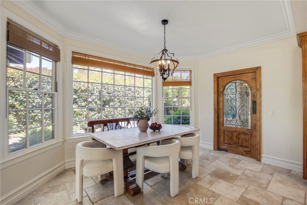 6032 Grey Rock Road Agoura Hills, CA 91301 - Photo 15 of 54 a dining room with furniture a chandelier and window