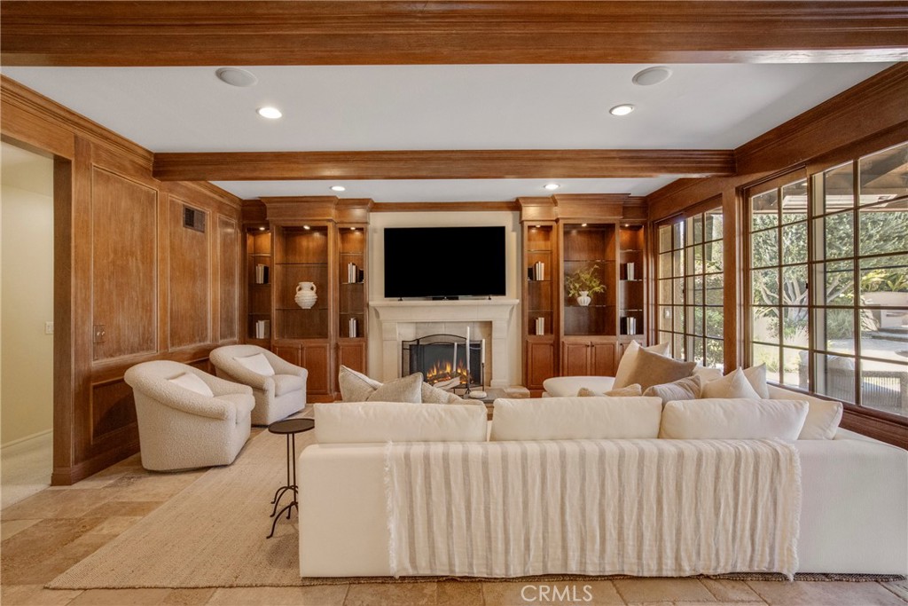 6032 Grey Rock Road Agoura Hills, CA 91301 - Photo 17 of 54 a living room with furniture a fireplace and a flat screen tv