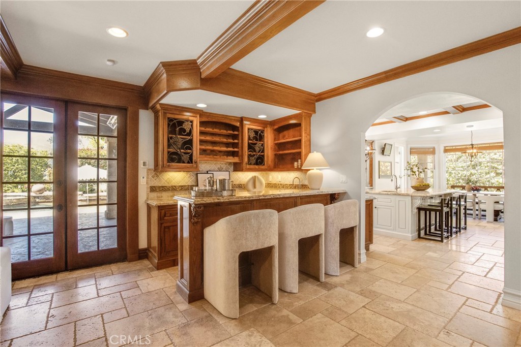 6032 Grey Rock Road Agoura Hills, CA 91301 - Photo 18 of 54 a dining hall with stainless steel appliances kitchen island granite countertop a large window and kitchen view