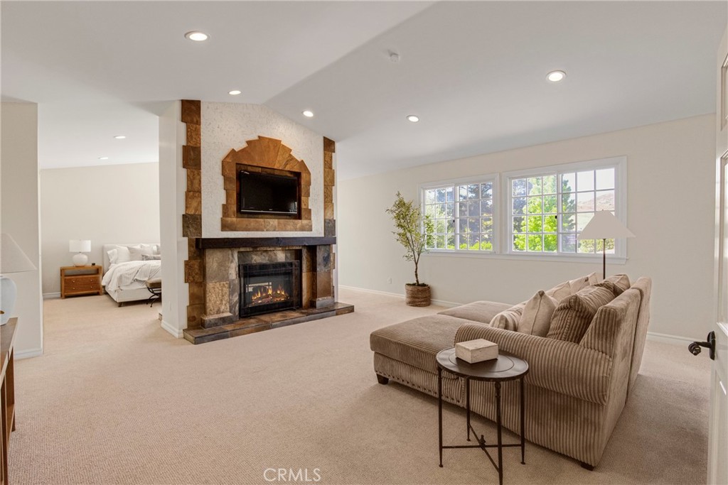 6032 Grey Rock Road Agoura Hills, CA 91301 - Photo 20 of 54 a living room with furniture and a fireplace
