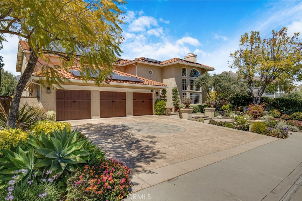 6032 Grey Rock Road Agoura Hills, CA 91301 - Photo 2 of 54 a front view of a house with a garden