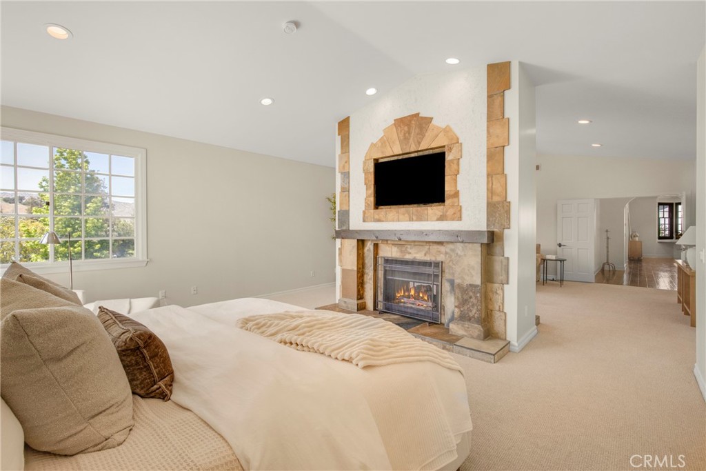 6032 Grey Rock Road Agoura Hills, CA 91301 - Photo 23 of 54 a spacious bedroom with a bed and a flat screen tv