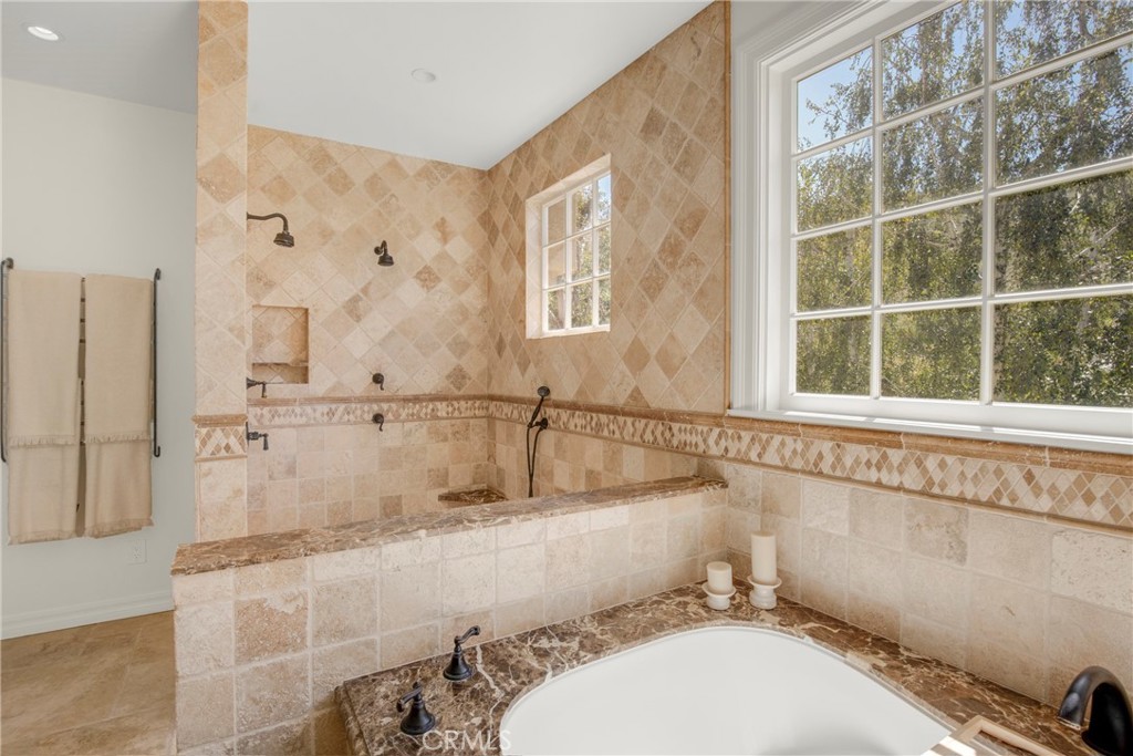6032 Grey Rock Road Agoura Hills, CA 91301 - Photo 25 of 54 a bathroom with a granite countertop sink and a bathtub