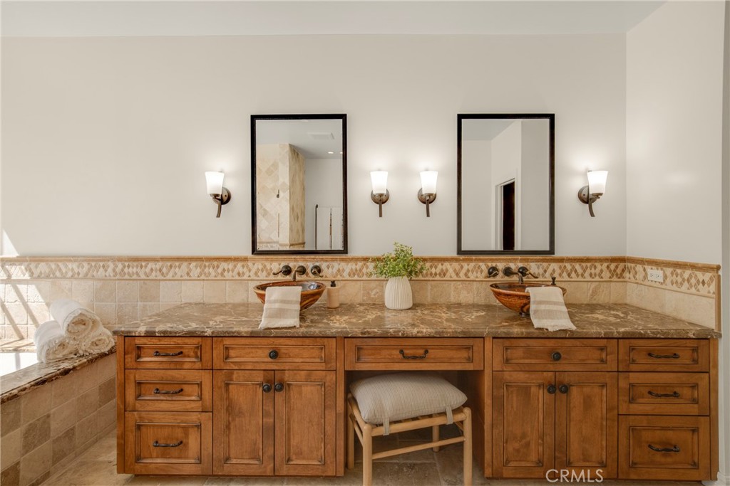 6032 Grey Rock Road Agoura Hills, CA 91301 - Photo 26 of 54 a bathroom with a granite countertop sink and a mirror