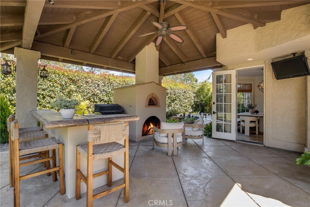 6032 Grey Rock Road Agoura Hills, CA 91301 - Photo 34 of 54 a view of a patio with table and chairs and potted plants
