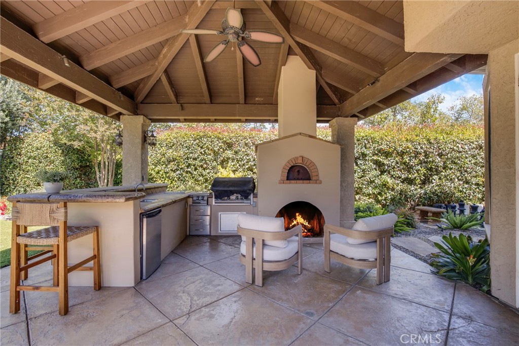 6032 Grey Rock Road Agoura Hills, CA 91301 - Photo 35 of 54 a living room with patio furniture and a fireplace