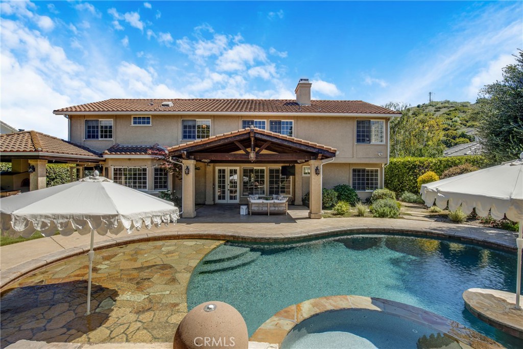 6032 Grey Rock Road Agoura Hills, CA 91301 - Photo 40 of 54 a view of a house with swimming pool and sitting area