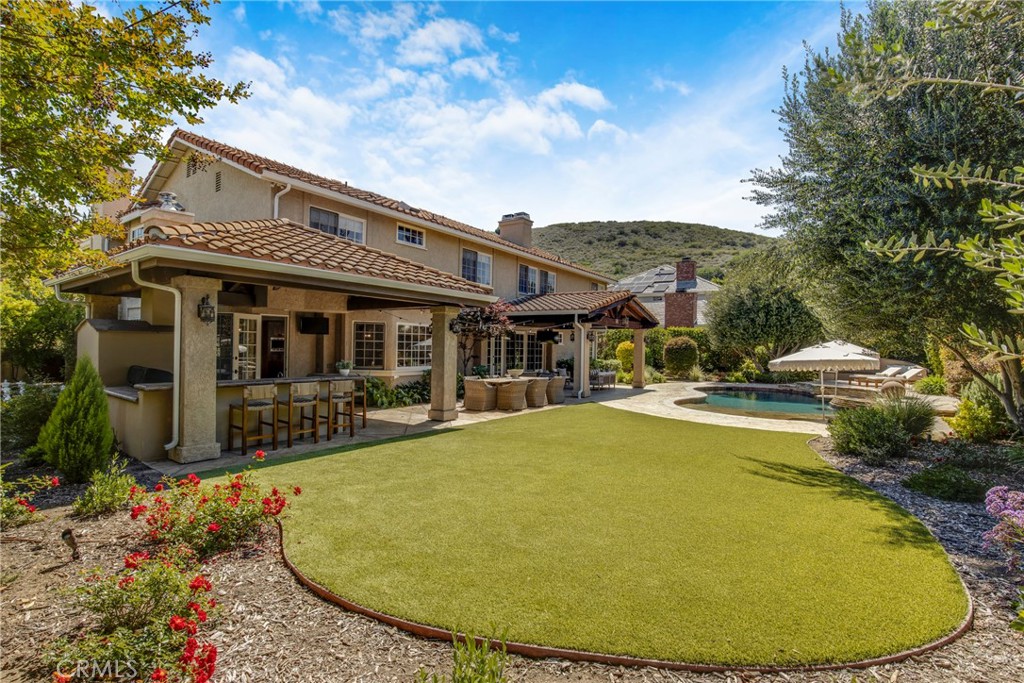 6032 Grey Rock Road Agoura Hills, CA 91301 - Photo 41 of 54 a view of a house with swimming pool and sitting area