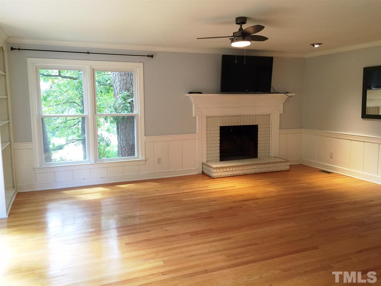 1900 Wilton Circle Raleigh, NC 27615 - Photo 5 of 9 a view of empty room with wooden floor and fireplace