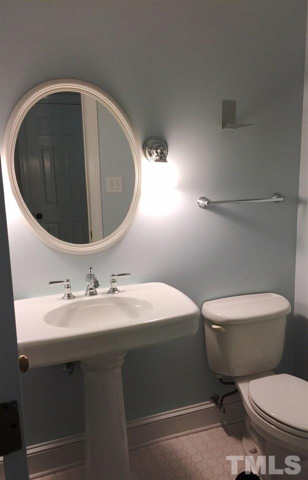 1900 Wilton Circle Raleigh, NC 27615 - Photo 8 of 9 a bathroom with a toilet sink and mirror