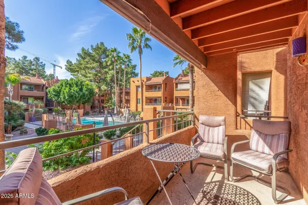 a balcony with table and chairs