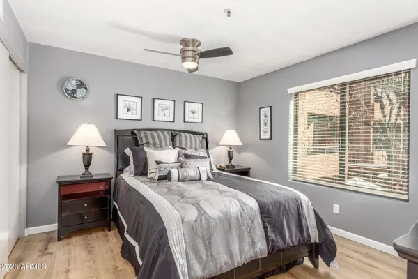 a bedroom with a bed and wooden floor