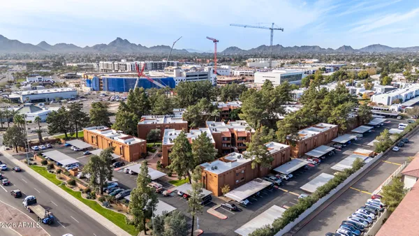 an aerial view of residential houses with city view