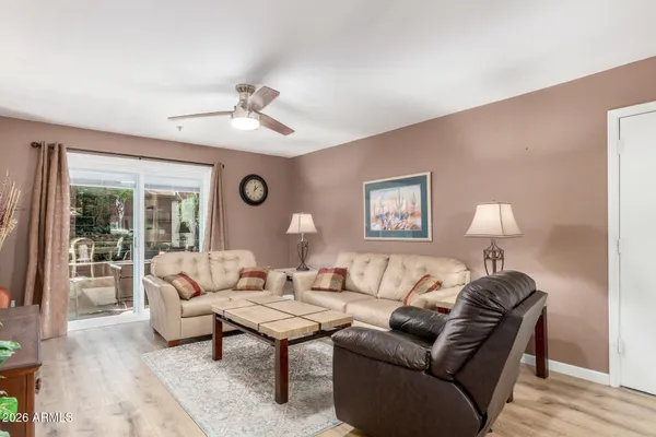 a living room with furniture and a lamp