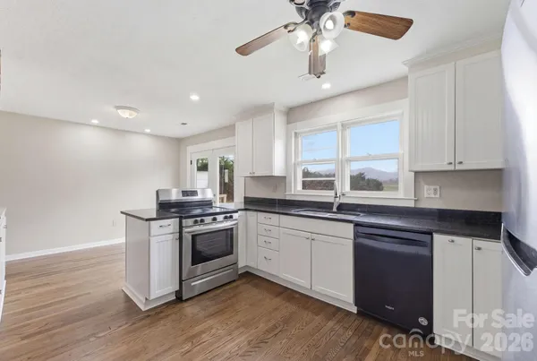 a kitchen with stainless steel appliances granite countertop a stove and a sink
