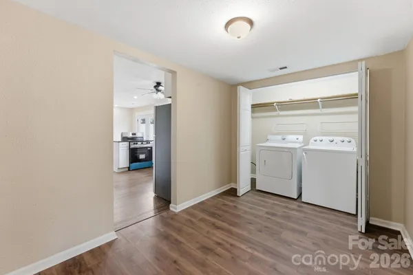 a view of a kitchen with a sink and a refrigerator