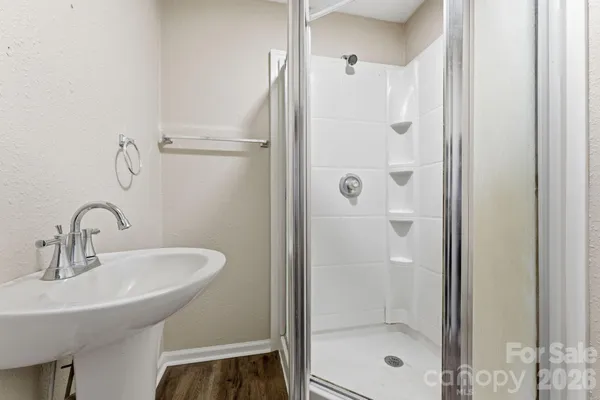 a bathroom with a shower and a sink