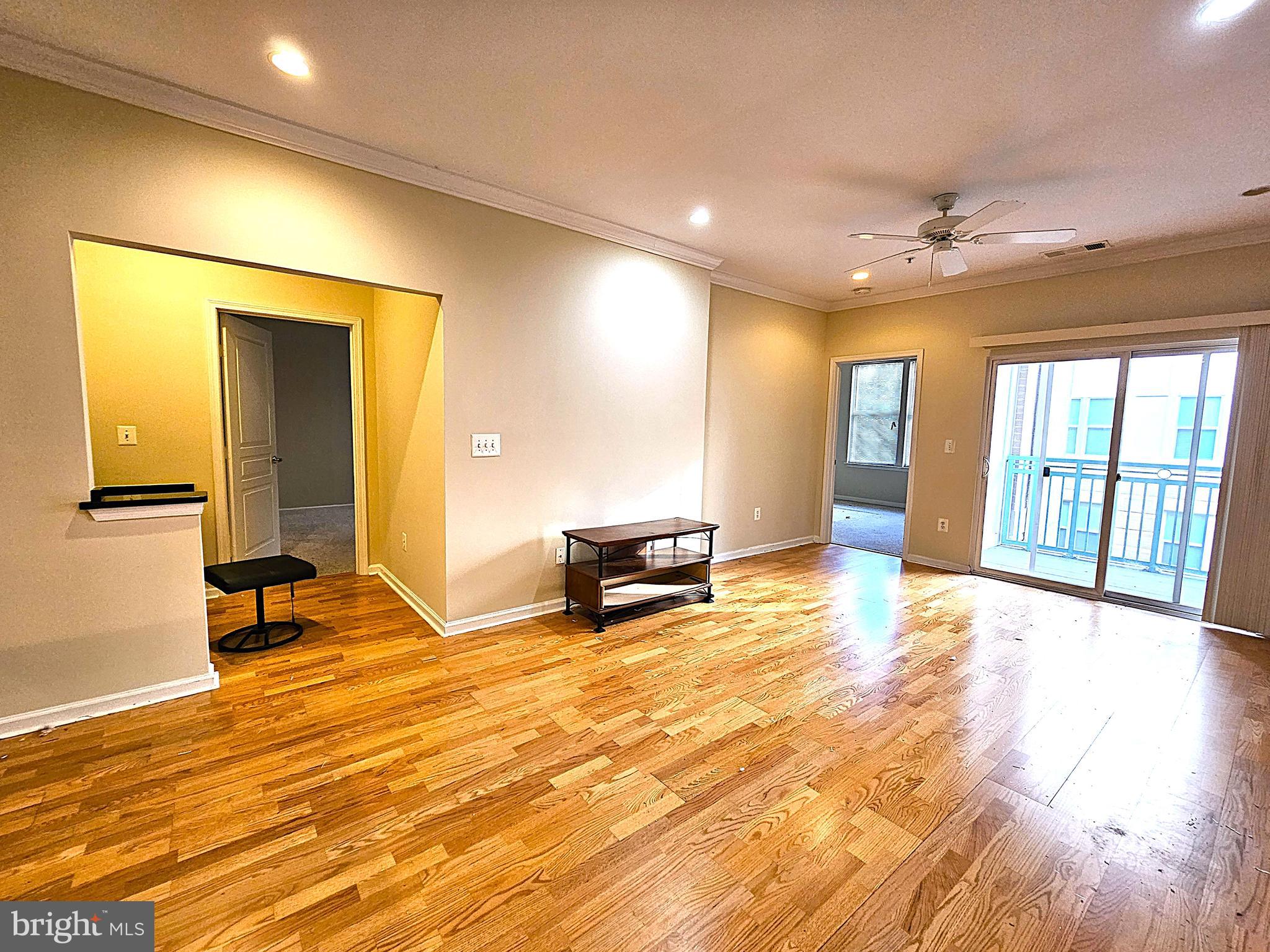 12000 Market Street, Unit 283 Reston, VA 20190 - Photo 16 of 36 a view of an empty room with glass door and furniture