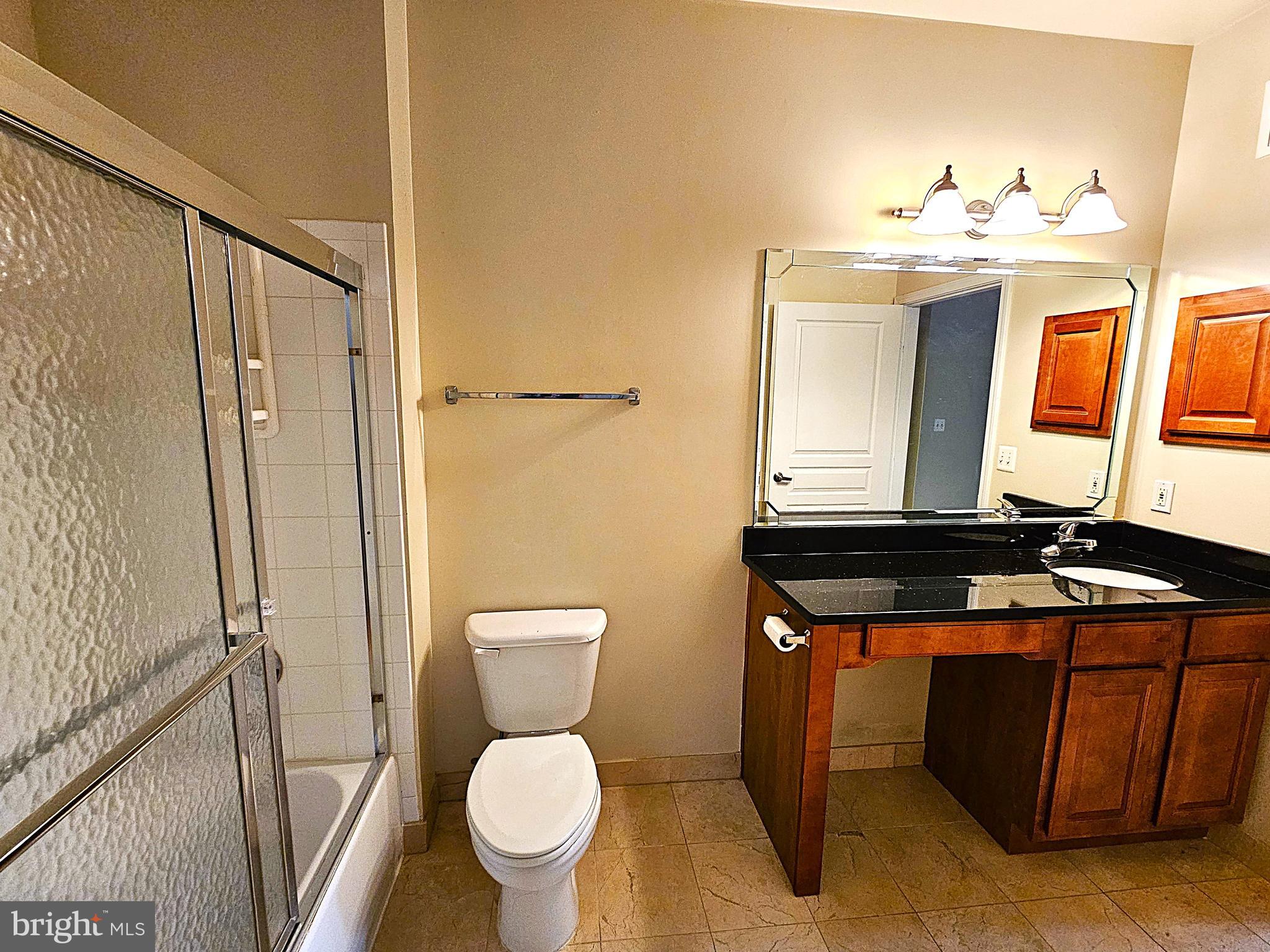 12000 Market Street, Unit 283 Reston, VA 20190 - Photo 24 of 36 a bathroom with a toilet sink and mirror