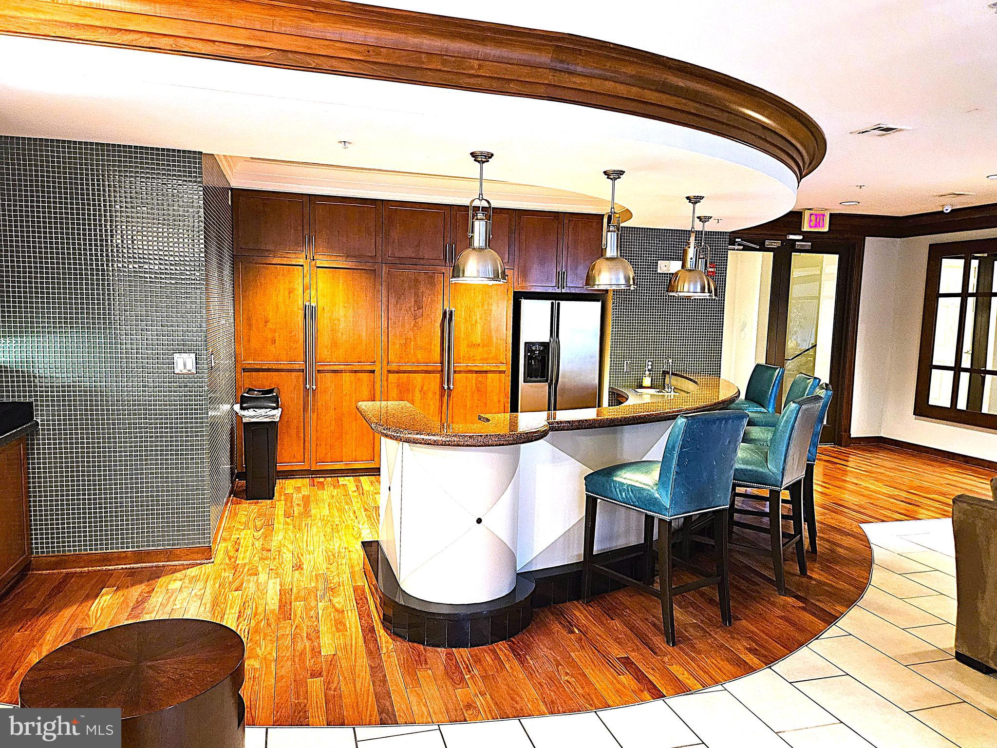 12000 Market Street, Unit 283 Reston, VA 20190 - Photo 30 of 36 a view of a dining room with furniture and wooden floor