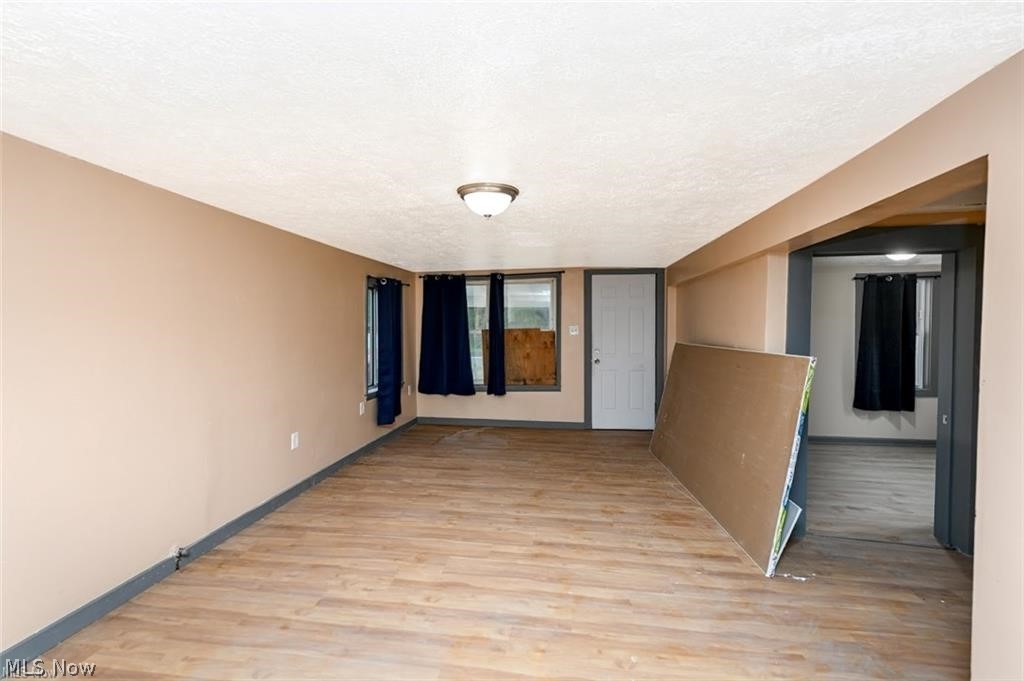 916 Abington Road Akron, OH 44312 - Photo 11 of 24 Wood-finish flooring throughout, neutral tone walls, and a ceiling-mounted light fixture