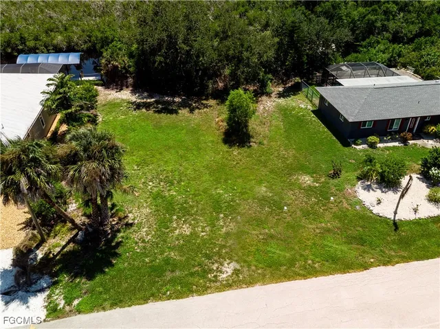 a backyard of a house with a yard and outdoor seating