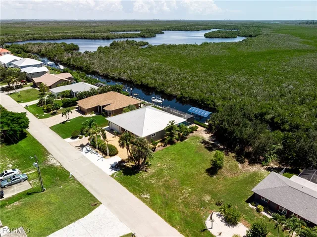 an aerial view of a house with a garden and lake view