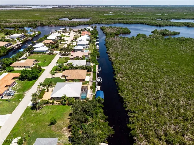 an aerial view of residential houses with outdoor space and river