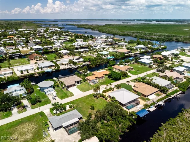 an aerial view of residential houses with yard