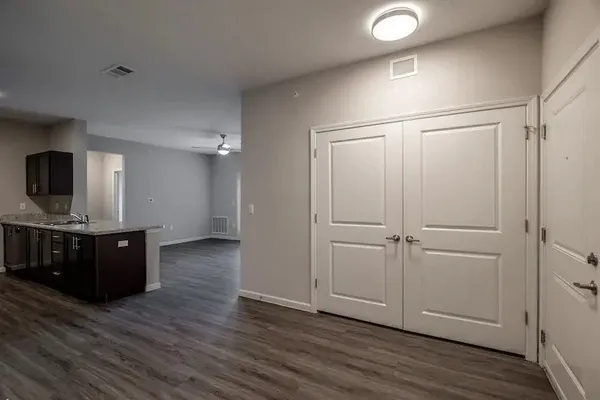 a view of kitchen with refrigerator microwave and wooden floor
