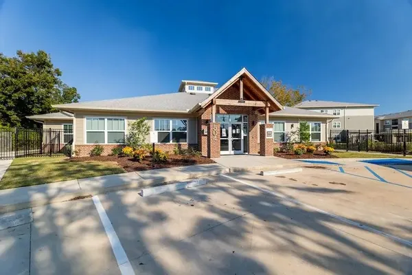 a patio with a table and chairs under an umbrella