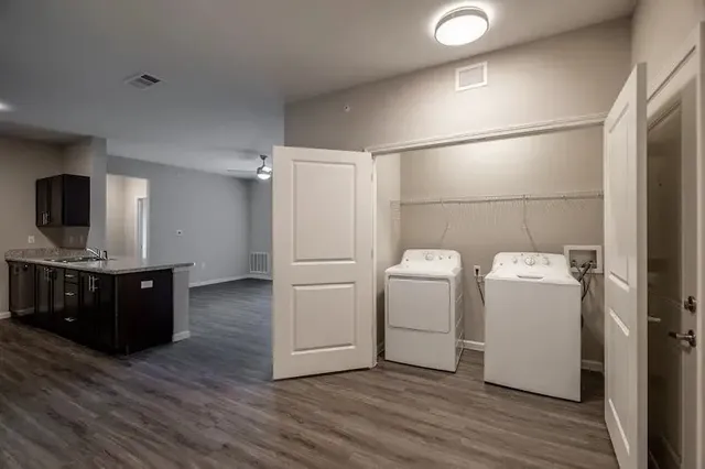 a view of a kitchen with wooden floor and cabinets