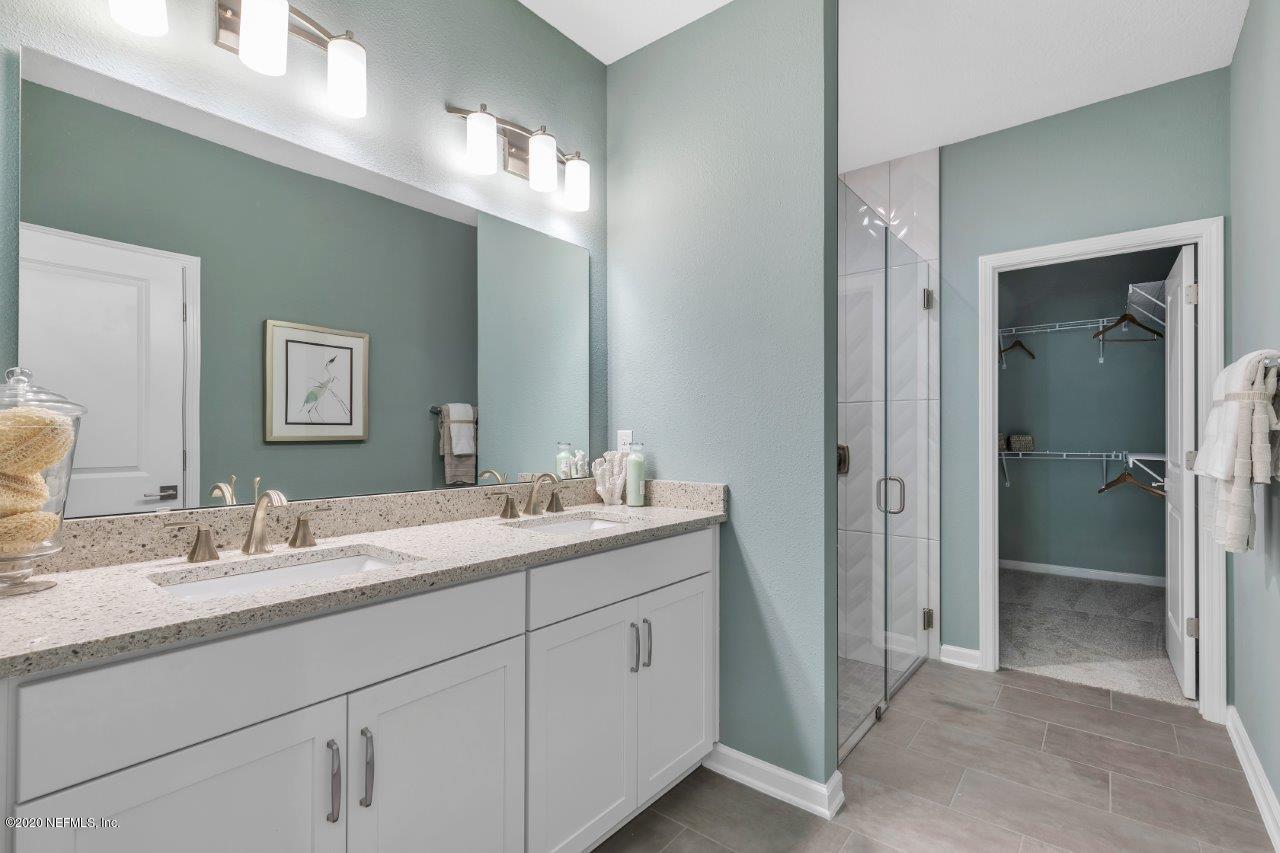 510 Modesto Drive St. Augustine, FL 32086 - Photo 16 of 38 a en suite bathroom with a double vanity sink and mirror