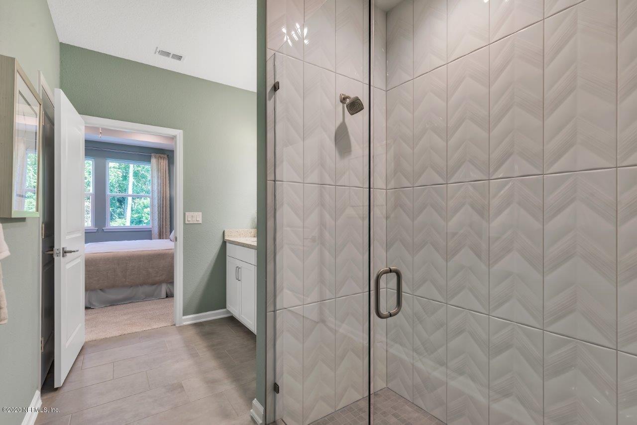 510 Modesto Drive St. Augustine, FL 32086 - Photo 17 of 38 a bathroom with a glass shower door and a sink