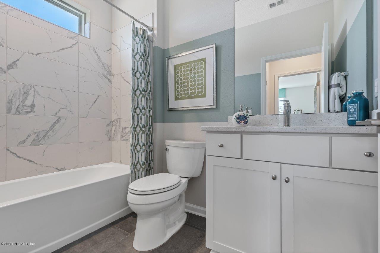 510 Modesto Drive St. Augustine, FL 32086 - Photo 19 of 38 a bathroom with a granite countertop sink toilet mirror and bathtub