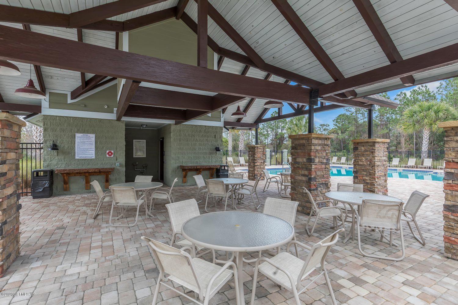 510 Modesto Drive St. Augustine, FL 32086 - Photo 21 of 38 a view of a patio with table and chairs and potted plants