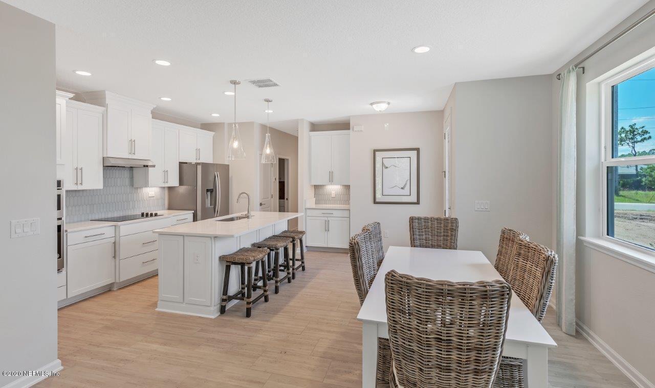 510 Modesto Drive St. Augustine, FL 32086 - Photo 7 of 38 a large kitchen with kitchen island a sink a center island stainless steel appliances and a window