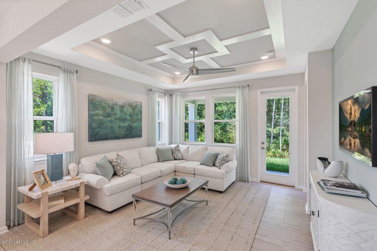 510 Modesto Drive St. Augustine, FL 32086 - Photo 8 of 38 a living room with furniture a flat screen tv and a large window