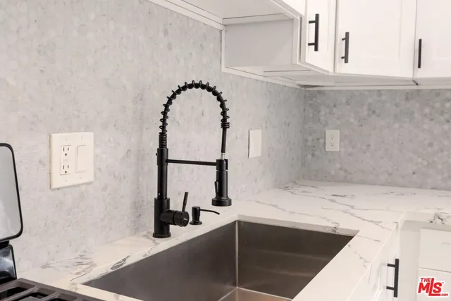 a bathroom with mirror sink and vanity