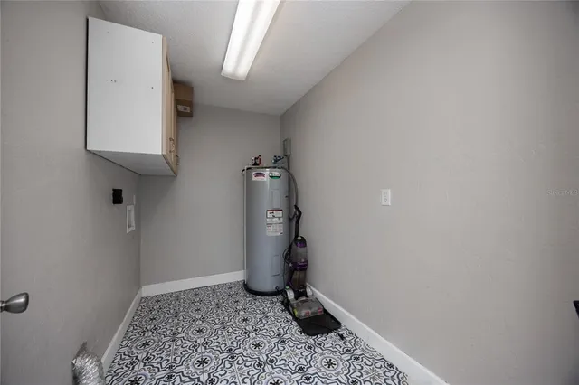 a kitchen with granite countertop a sink stove and refrigerator